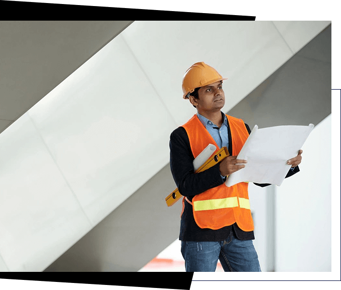 A man wearing a hard hat and a reflective vest looks at a set of blueprints while holding a clipboard and a level, demonstrating precision that top recruiting services seek in skilled professionals.