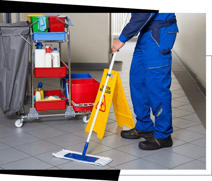 A janitor in blue overalls mops a tiled floor next to a cleaning cart with supplies and a yellow "Caution Wet Floor" sign, demonstrating the quality staff you can find through top-notch recruiting services.